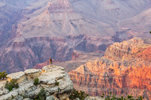 man looking out over Grand Canyon landscape 