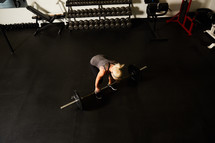 a woman lifting weights in a gym 