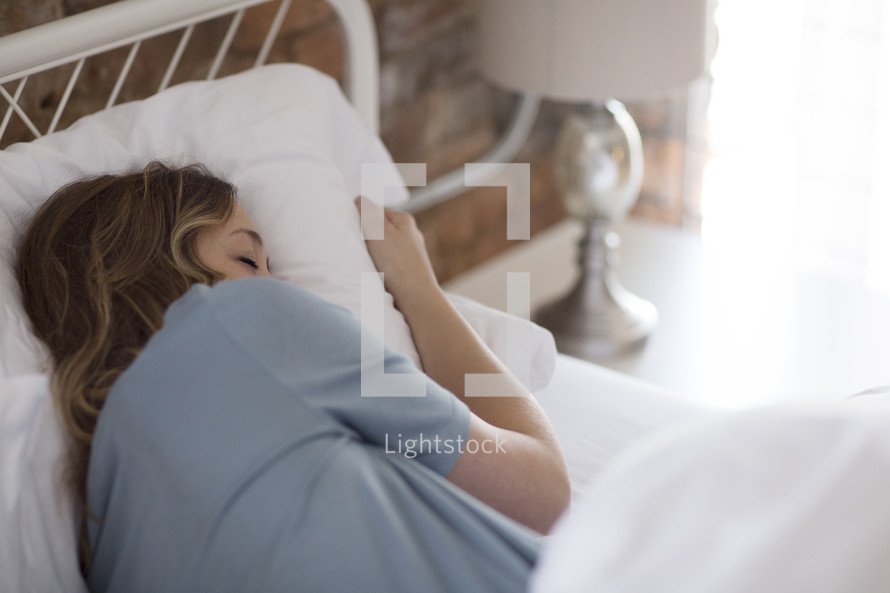 a woman sleeping in bed 