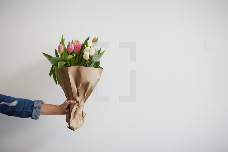 arm holding out a bouquet of flowers 
