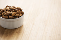 Raw almonds in a ramekin bowl. 