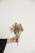 a woman holding out flowers 