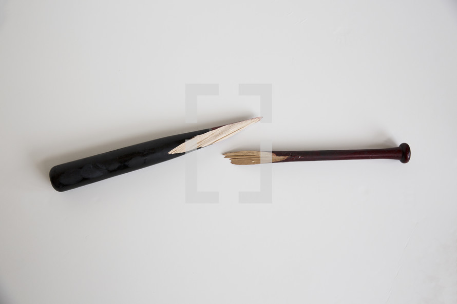 a broken baseball bat against a white background.