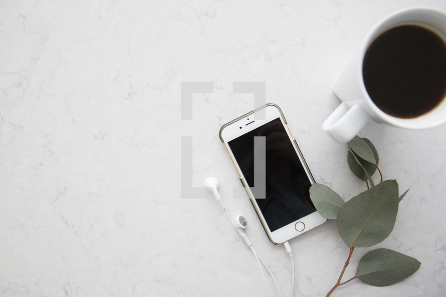 coffee mug, iPhone, earbuds, eucalyptus, leaves, desk, workspace, office, home office, white background 