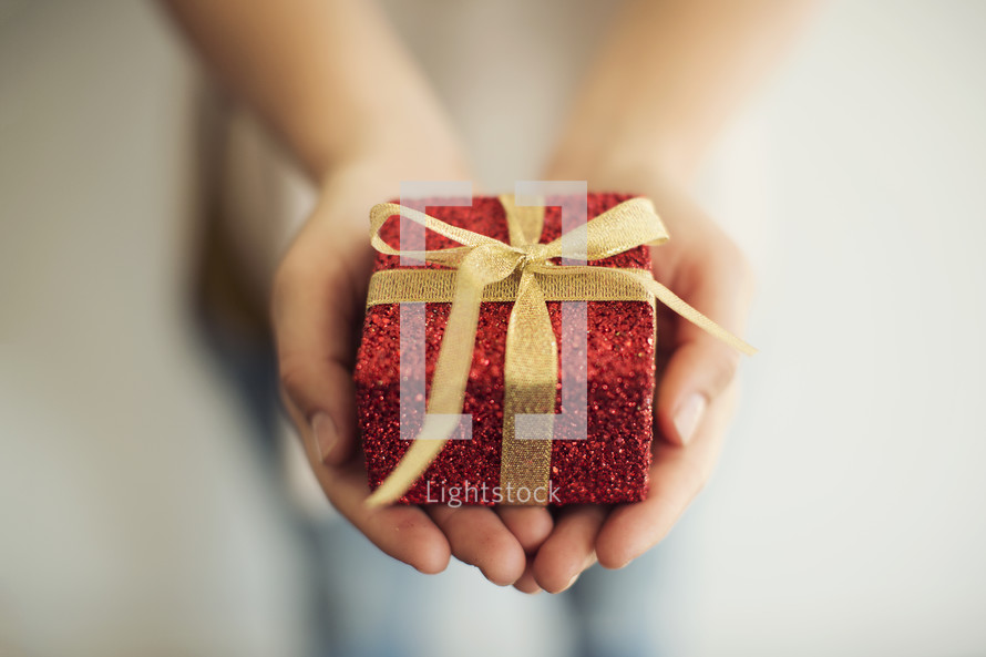 a woman holding a wrapped gift.
