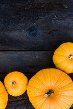 Fall, harvest, pumpkins on dark wood background, border, frame,  vertical