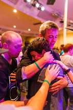 Man embracing young man, boy crying, prayer, love, healing