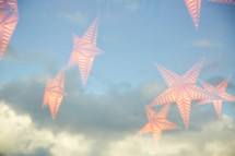 double exposure hanging star lights and clouds in the sky 