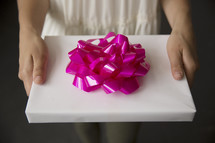 woman holding a wrapped gift 