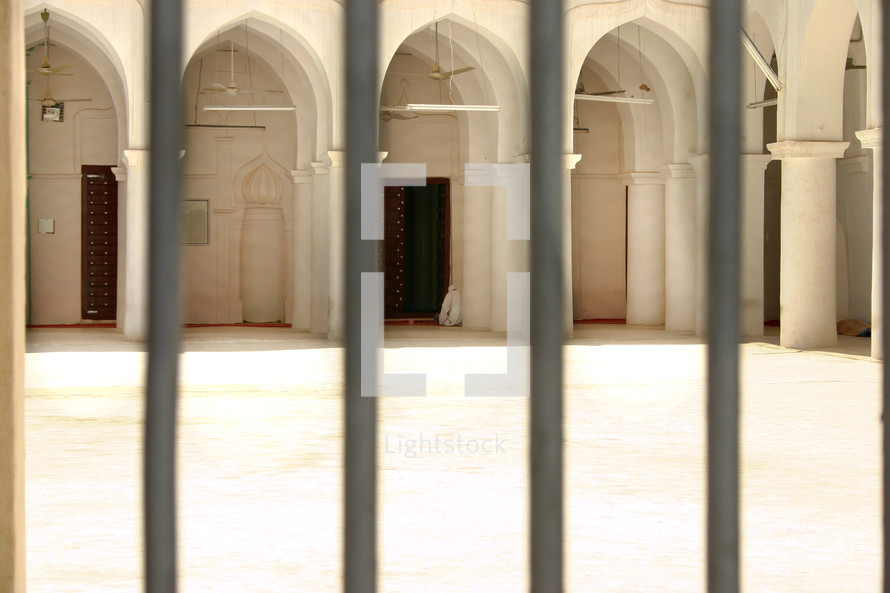 doors of a mosque through a fence 