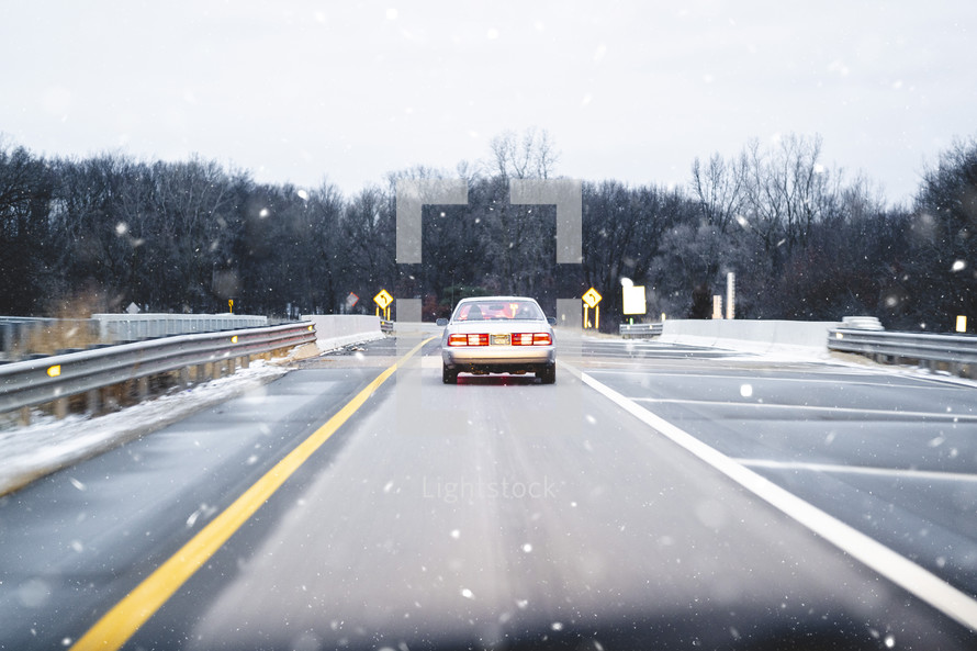Snow falling on a drive