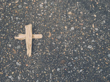 wooden cross on asphalt 