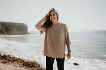 a young woman standing on a beach in Palos Verdes 