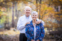 a portrait of an elderly couple in fall outdoors 