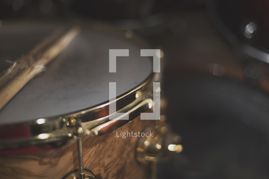 a close up of a snare drum and well used sticks
