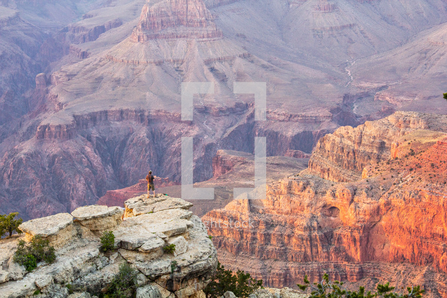 man looking out over Grand Canyon landscape 