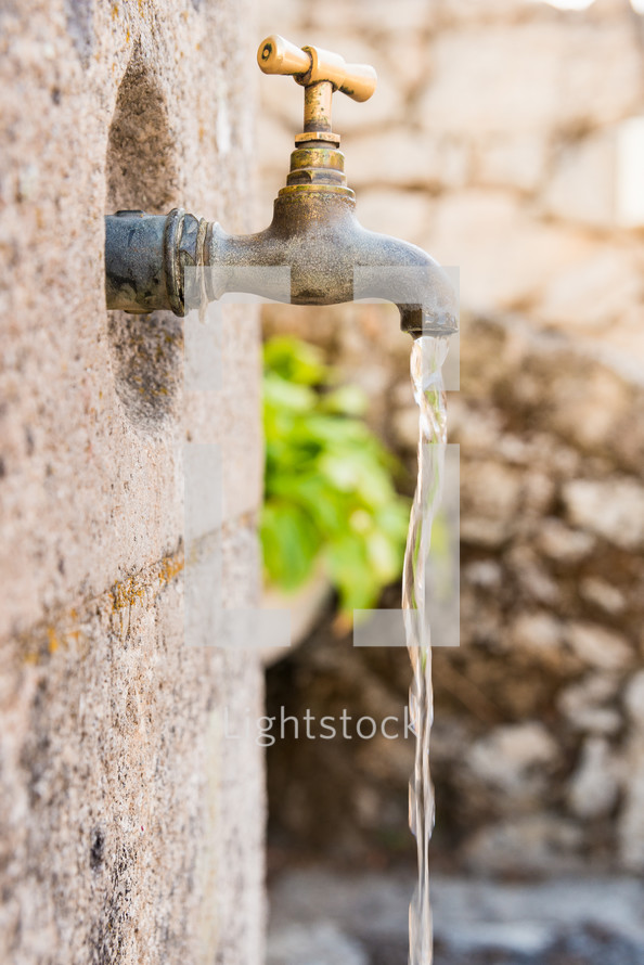 water pouring out of a spigot 