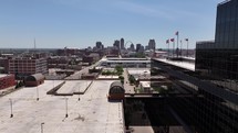 Aerial drone footage of downtown St. Louis, MO on a clear blue sky summer day looking at skyscraper buildings.