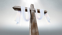 white shroud on a wooden cross