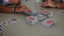 Senior citizens playing a game of cards