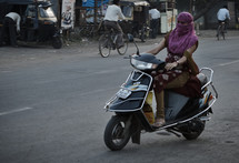 Woman in central India riding scooter