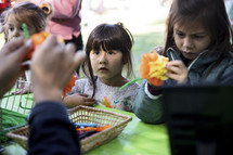 Little girls creating flowers at a fall festival
