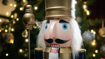 Nutcracker in front of Christmas tree