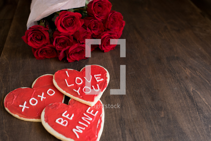 Valentine's cookies and bouquet of red roses 