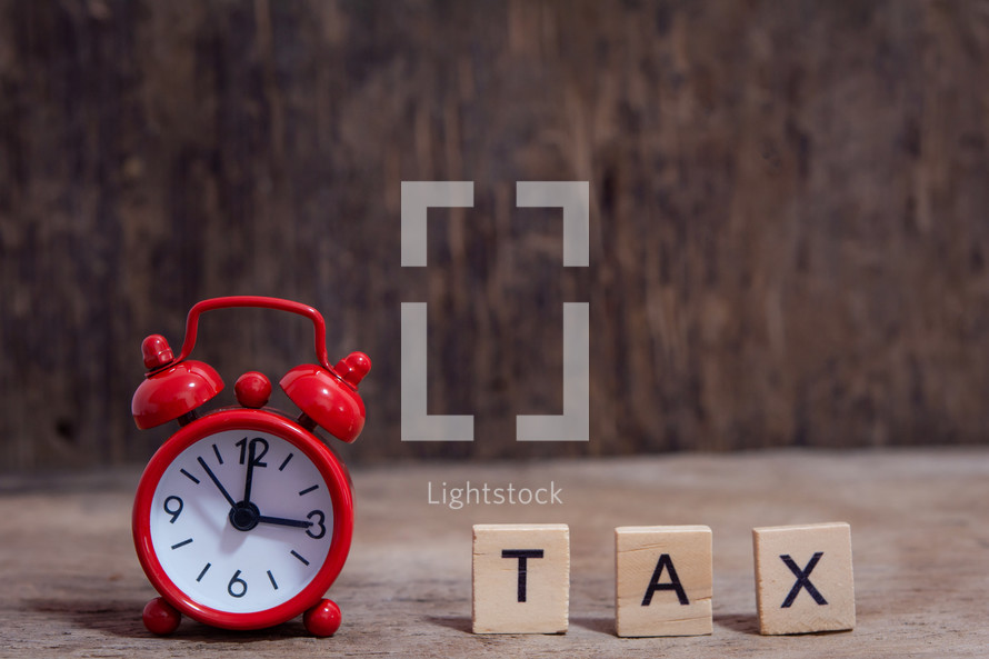 alarm clock and the word tax 