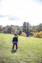 Little girl standing in a field