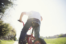 a boy child riding a bike 