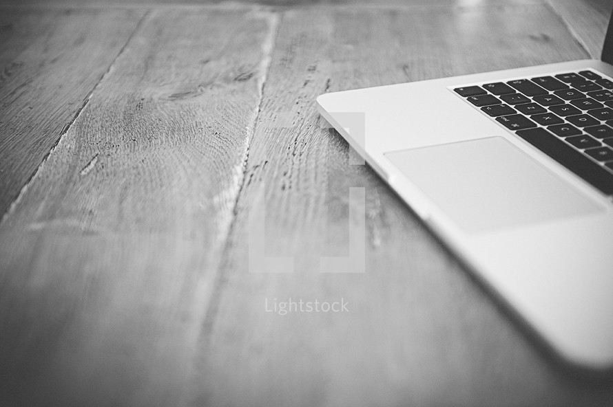 a laptop on a wood floor 