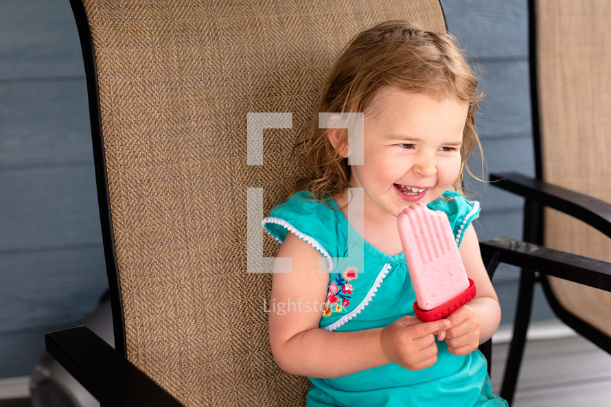 child eating a popsicle 