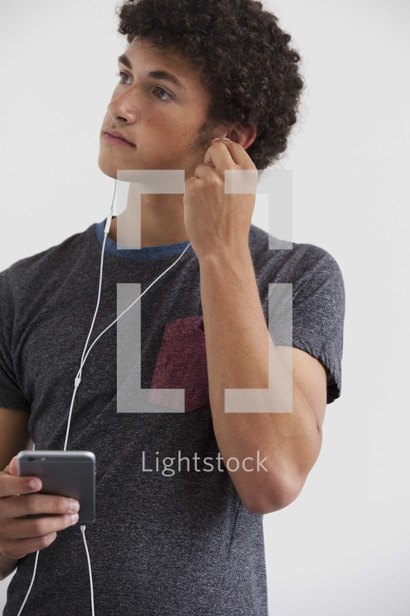 teen boy listening to earbuds 
