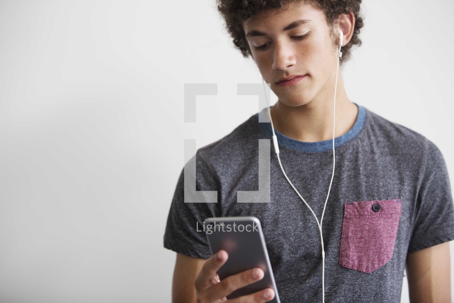 teen boy listening to earbuds 