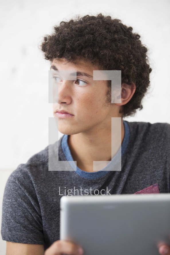 a teen boy using a tablet 