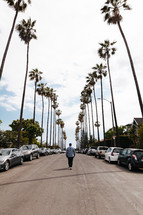 a man walking in the middle of a California street 