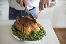 a man carving a turkey 
