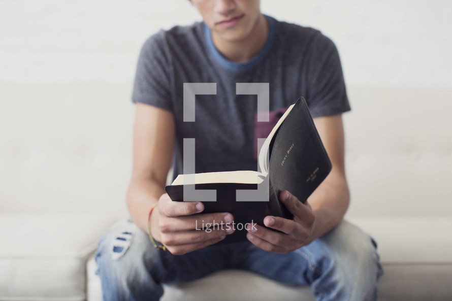 a young man reading a Bible 
