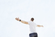 a man standing with arms outstretched 