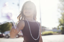 a little girl playing dress up. 