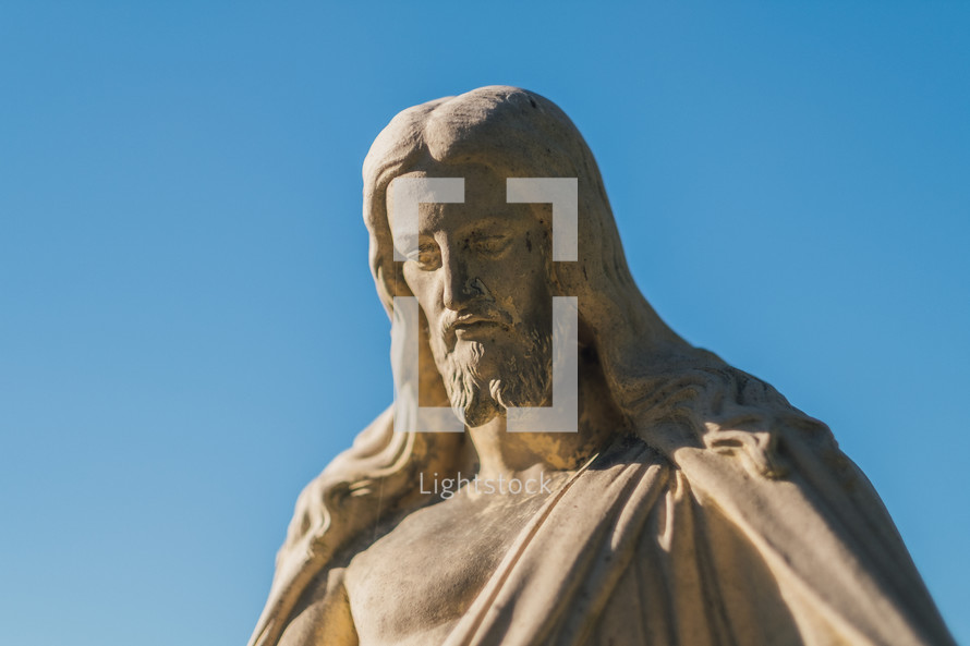 Stone statue of Jesus with clear, blue sky
