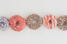 a row of sprinkled donuts 