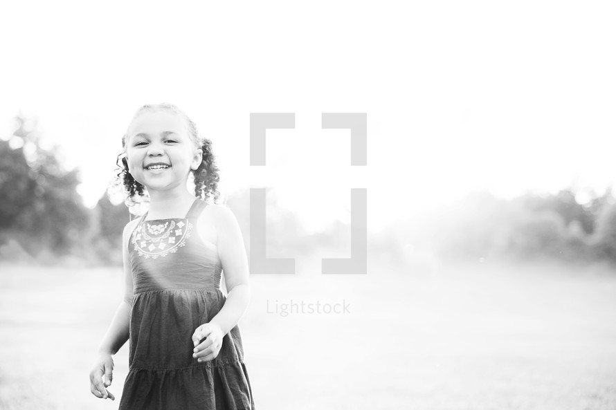toddler girl running outdoors 