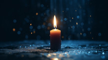 One candle burning at Christmas at night with bokeh background. 