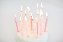flames on birthday candles on a cake