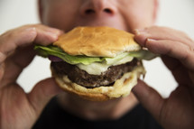 a man eating a hamburger 