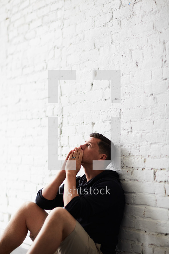 a man sitting alone praying 