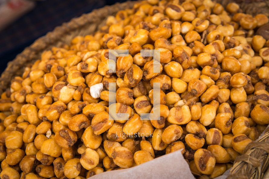 a pile of toasted salted corn on a Wicker basket