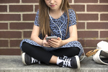 a little girl listening to music on an iPod 